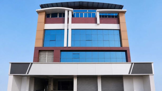 A multi-story building with a flat roof, large windows, and a covered entrance. - Deluxe Hotel Ashoka Grand (Sadasivpet)