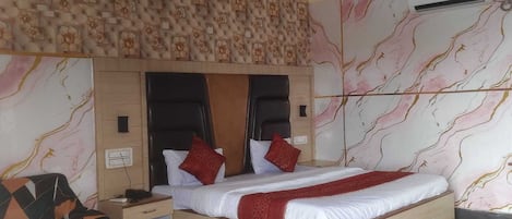 A bedroom with a bed, nightstand, and a chair.