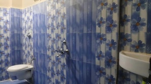 Un baño con inodoro, ducha y lavamanos.