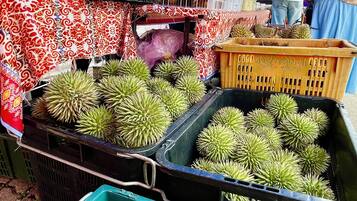 A market stall with durians displayed in crates.