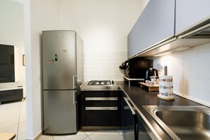 A compact kitchen with a stainless steel refrigerator, a gas stove, and a sink. - Bright and cozy 70 sqm apartment, accommodating up to 5 guests, located on the ground floor of an elegant, renovated building dating back to the early 20th century (access involves a few steps). The property is located in a quiet neighborhood offering al (Siena)