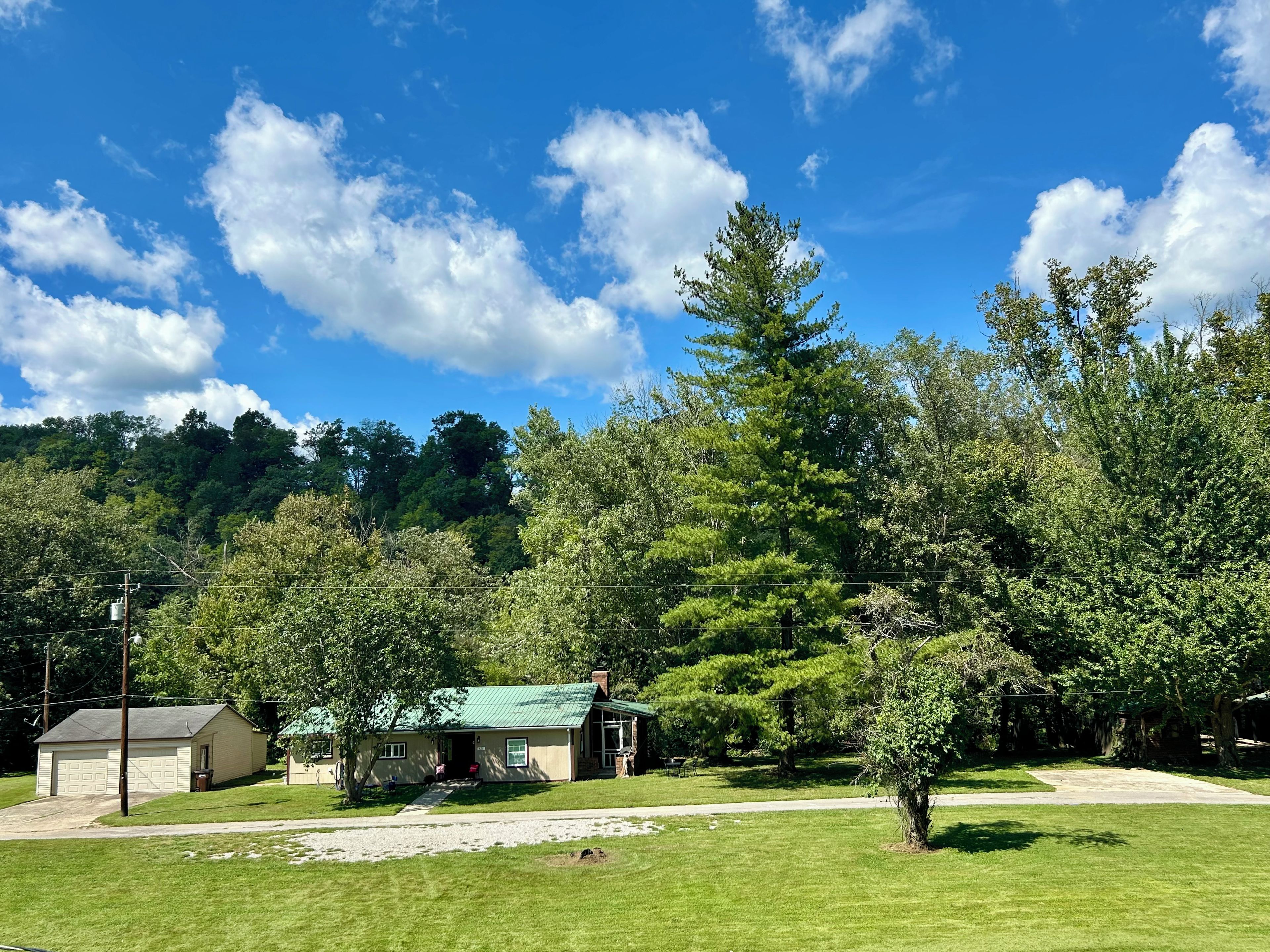 A residential property with a detached house, a garage, and a well-maintained lawn.