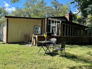 A small, single-story building with a brick exterior and a covered porch.