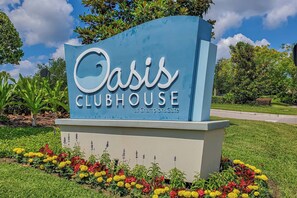 A sign for Oasis Clubhouse at ChampionsGate. - ChampionsGate 4BR | Private Pool + Waterpark (Kissimmee)