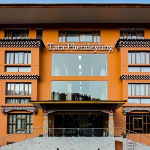 A building with a sign reading 'Tara Phendeyling' and a staircase leading to the entrance.