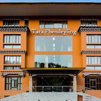 A building with a sign reading 'Tara Phendeyling' and a staircase leading to the entrance.