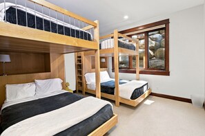 A bunk bed room with a window, a ladder, and a desk. - Exceptional Arrowhead Riverfront Retreat | Hot Tub & 2-Car Garage (Edwards)