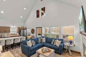 A spacious living room with a sectional sofa, a dining area, and a kitchen. - New! Cottage by the Bay | 3 Min Walk To Dover Bay Marina | Pet Friendly | AC (Dover)