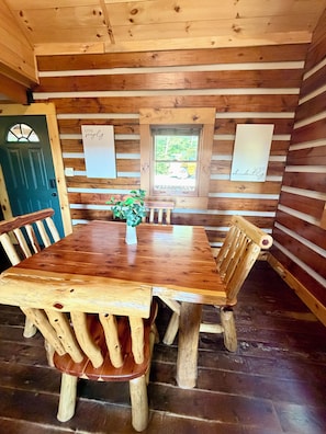 A wooden interior with a dining table, chairs, and a bench. - NEW LISTING PROMO Sunset Bluff Overlook Cabin in the RRG•
Hot Tub• Fireplace (Pine Ridge)