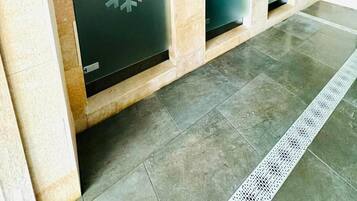 A row of private changing rooms with frosted glass doors, each with a snowflake design.
