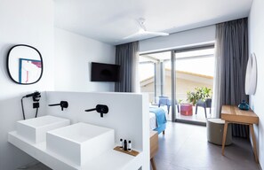 A modern hotel bathroom with a large white bathtub, a wall-mounted TV, and a balcony with outdoor seating. - Exquisite Nikiana Villa with Sea Views and Pontoon Access near Tavernas (Lefkada)