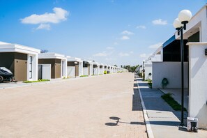 A row of modern, white buildings with a clear sky.
