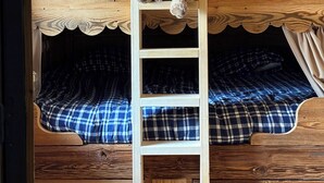 A bunk bed with a ladder, a teddy bear, and a heart-shaped decoration. - Le JUGA: A Cozy Cabin in the Heart of the Forest (Bolquère)