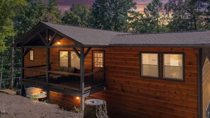 A cabin with a deck, a hot tub, and a large window. - The West Nest - Ellijay,GA (Ellijay)