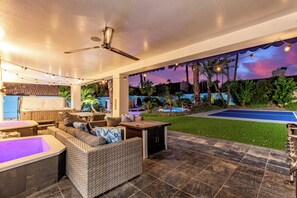 An outdoor patio with a pool, seating area, and a ceiling fan. - Elite Luxury Pickleball Palace-Heated Pool (Scottsdale)