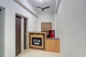 A hotel reception area with a signboard indicating 'HOTEL Company Serviced'. - Hote O Iiit Square Bhubaneswar (Bhubaneshwar)