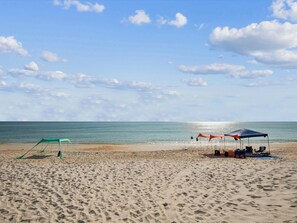 A beach with a tent and a hammock. - 754 Cinnamon Beach | Oceanfront + Resort Amenities (Palm Coast)