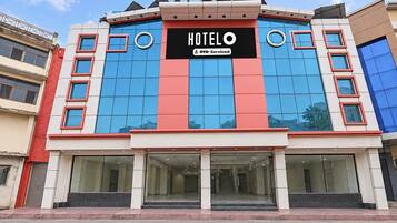 A hotel building with a prominent sign reading 'HOTEL' and 'OYO-Serviced'.
