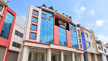 A hotel with a modern facade, large windows, and a prominent sign.
