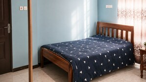 A bedroom with a bed, a wooden door, a window with curtains, and a ceiling with exposed beams. - Adorable 4-bedroom bungalow in terrific Taita Taveta location (Taita Taveta)