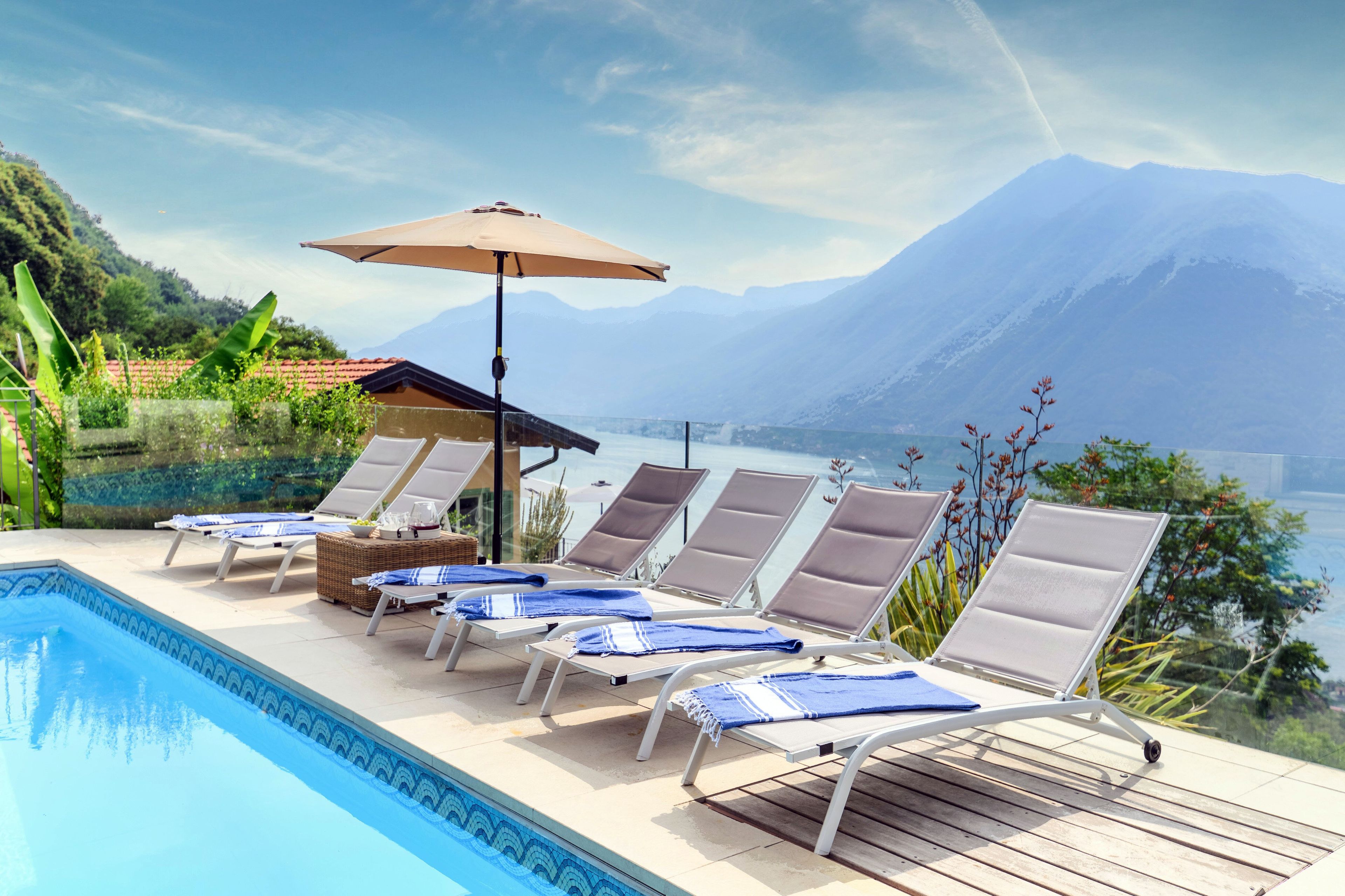 A poolside area with lounge chairs and a pergola.