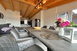 Um interior moderno com área de jantar, cozinha e sala de estar.
