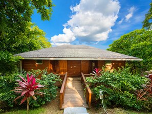 A wooden cabin with a porch and a staircase leading to the entrance. - Casa Promesa  Infinity Pool & Ocean Views (First Bight)