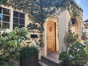 A building with a wooden door, a mailbox, and a number '4065A' on the wall. - Comfy 2 Bedroom Bungalow near Sony Studios (Culver City)