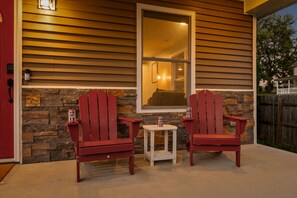 Two Adirondack chairs outside a house with a stone wall and a window. - Hoosier Hideaway | King Bed, Beer Pong, Shotski (Bloomington)