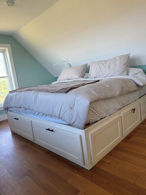 A bedroom with a bed, a window, and a ceiling light. - Remote tiny home/loft overlooking the Roanoke Sound & the Outer Banks (Manns Harbor)