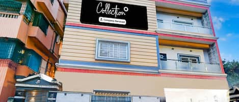 A multi-story building with a sign that reads 'Collection Company Service.'