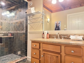 A bathroom with a shower, vanity, and a towel rack. - Slopeside Estate Guesthouse: Hot tub, AC, Grill (Killington)