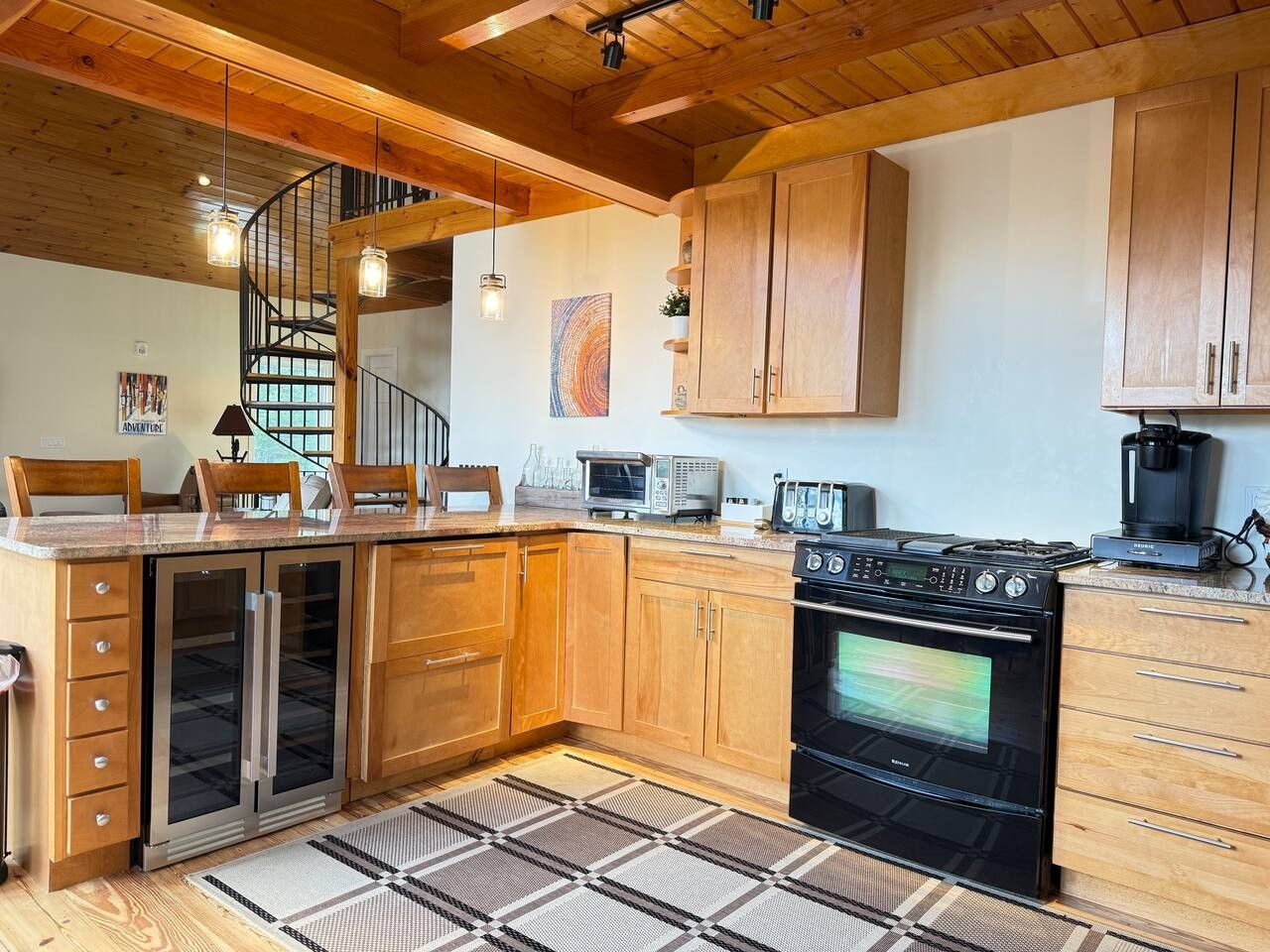 A kitchen with wooden cabinets, a built-in oven, a microwave, and a coffee maker.