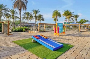 A playground with a blue slide and orange and yellow play structures. - 4BR townhouse at Regal Oaks (Kissimmee)