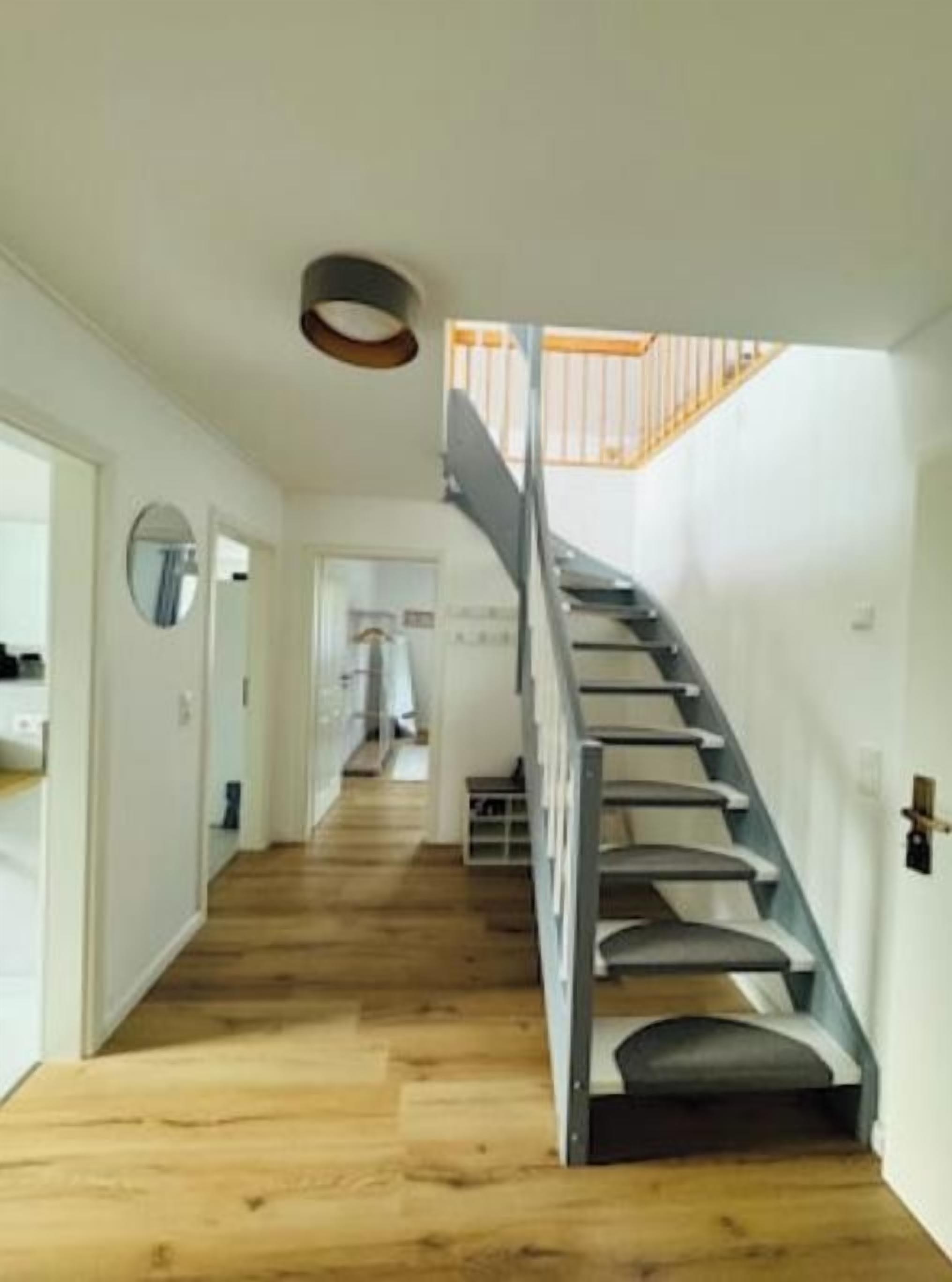 A staircase with a handrail leading to a landing.