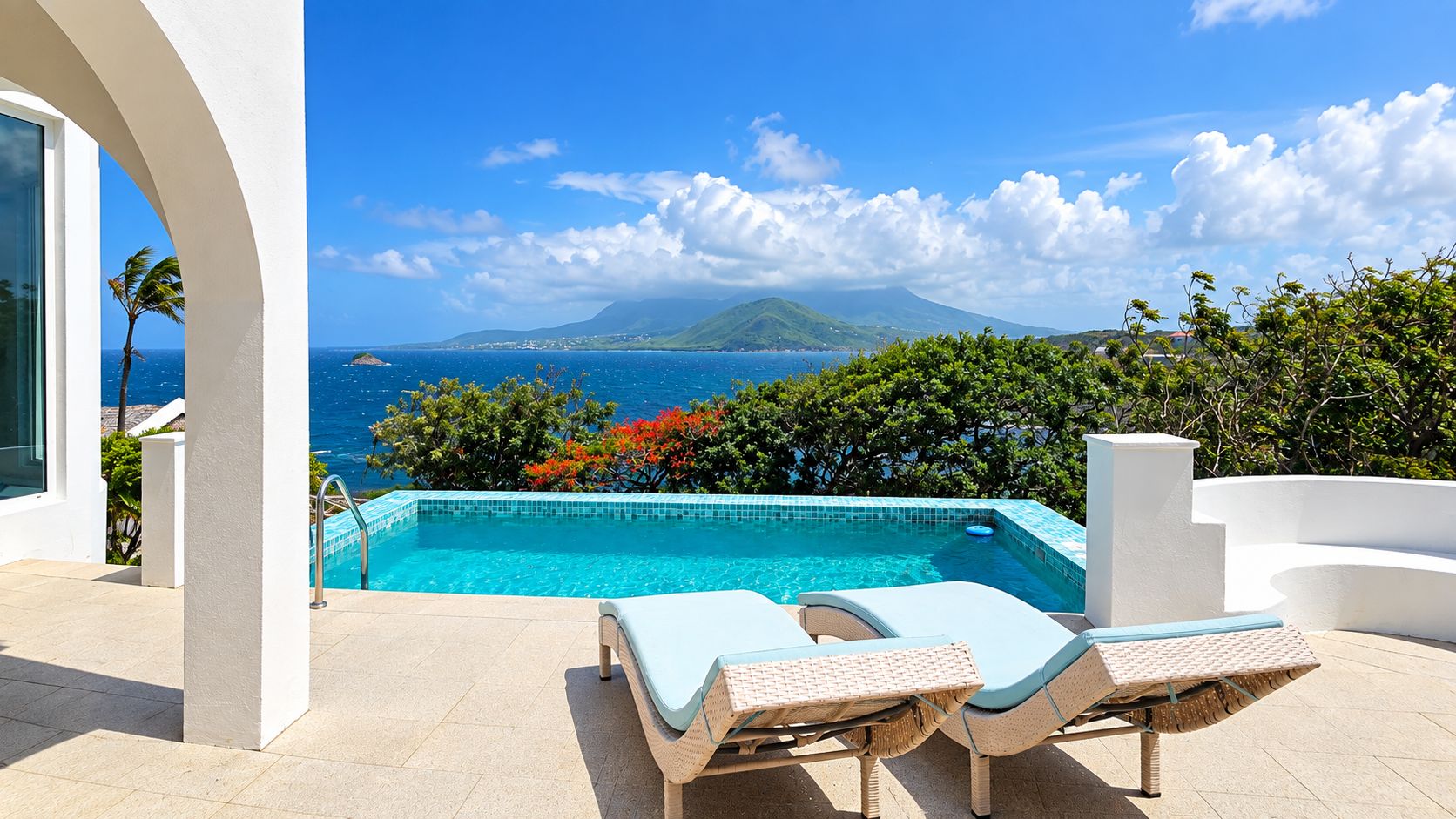 A swimming pool with a view of the ocean and a mountain in the background.