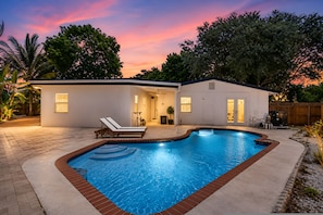 A residential property with a swimming pool, a covered patio, and a detached garage. - Sunset Paradaise in Fort Lauderdale (Fort Lauderdale)