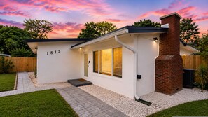 A modern house with a brick chimney, numbered 1517, white exterior walls, and a paved driveway. - Sunset Paradaise in Fort Lauderdale (Fort Lauderdale)