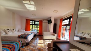A hotel room with two beds, a sofa, a chair, a desk, and a large mirror. - CASA RENTERA D'ELIAS (San Cristóbal)