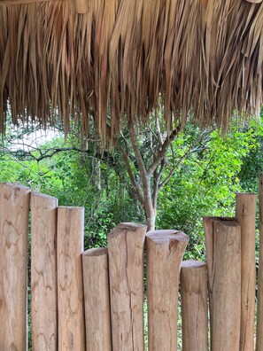 A wooden fence with a thatched roof structure. - Ki-Ra Holistic Living (San Rafael del Yuma)