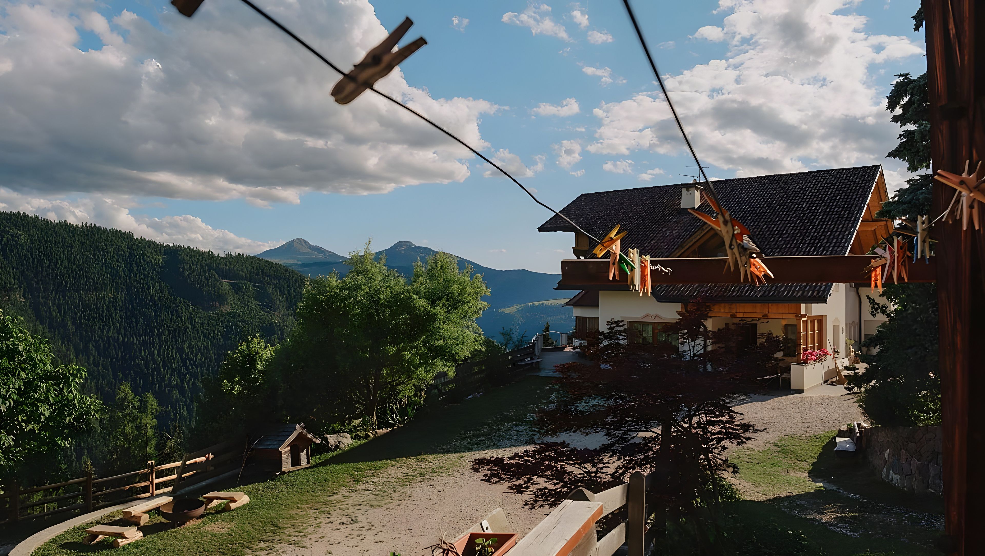 A mountain house with a view of the surrounding forest and mountains.