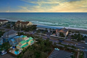 A coastal residential area with beachfront properties, a main road, and a parking lot. - Summer Sun (Destin)