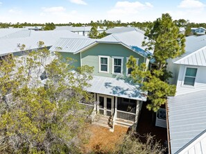 A residential area with multiple houses, one with a porch and a covered front area. - Sea Esta (Santa Rosa Beach)