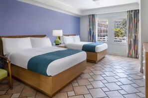 A hotel room with two beds, a nightstand with a lamp, a chair, and a view of the outside. - Top-View Oceanside 2BR Villa, Beachfront Marriott St. Kitts – Dec 8–15, Sleeps 8 (Frigate Bay)