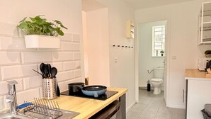 A modern kitchen with a dishwasher, a sink, and a countertop. There is a window with a view of the outside. - Le BARN -> a stylish urban retreat ❤️ (Le Havre)