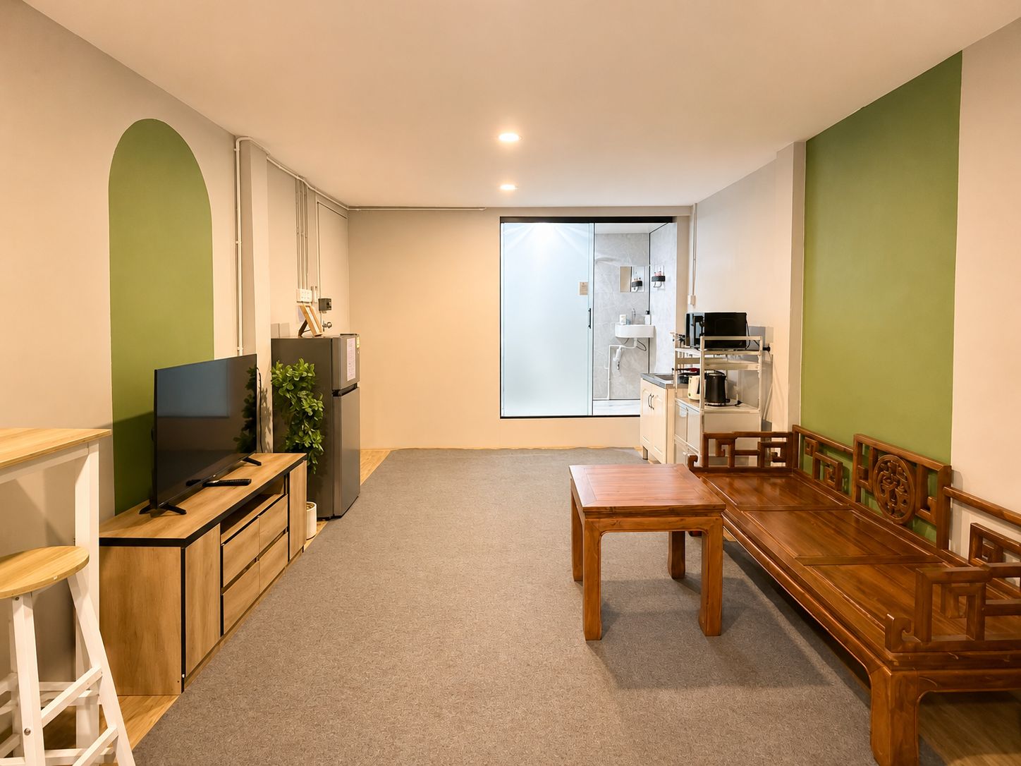 A compact living space with a kitchenette, a dining area, and a seating area.