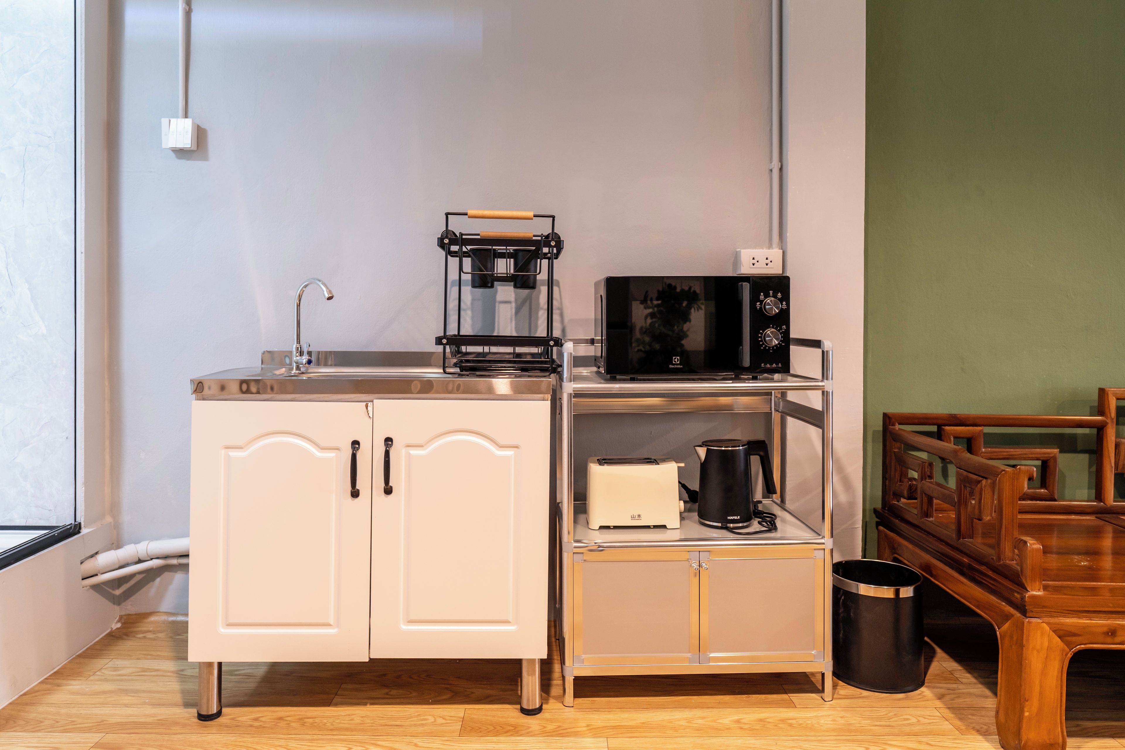 A kitchenette with a sink, a microwave, a toaster, and a coffee maker.