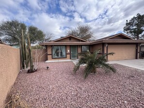 A two-story house with a garage, surrounded by a gravel driveway and cacti. - Next  to the strip cozy home in Vegas (North Las Vegas)