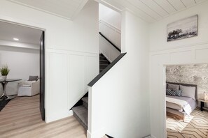 A modern interior with a staircase, a dining area, and a living space. - Park City Ski Getaway | Private Hot Tub | Fireplaces | Sleeps 10 (Park City)