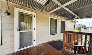 A covered porch with a wooden deck, a metal roof, and a door with a screen. - Private 3-bedroom home with dedicated workspace across Randolph Air Force Base (Converse)